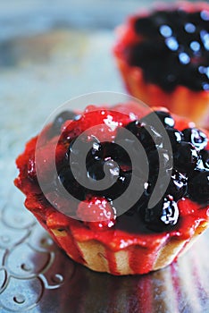 Tasty cup cake with berries on metal tray