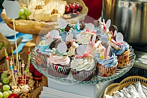 Tasty cupcakes on a crystal dish with empty white signs.