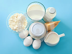 Tasty dairy products with eggs on color table