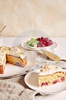 Tasty and delicious cake with baiser and  raspberries on a plate photo