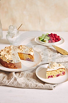 Tasty and delicious cake with baiser and  raspberries on a plate photo