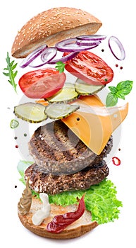 Tasty delicious hamburger ingredients flying in the air layer upon layer. Clipping path