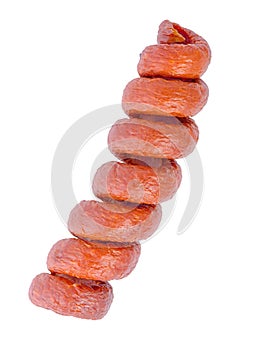 tasty delicious smoked dried spiral red sausages, salami is isolated on white background, close up