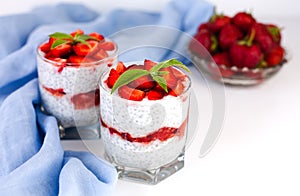 Tasty dessert with fresh strawberry, yogurt and chia seeds on white background. Healthy food concept. ?lose-up. Copy space