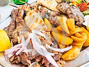 Tasty dish with greek tzatziki sauce, a mixture of various types of grilled meat