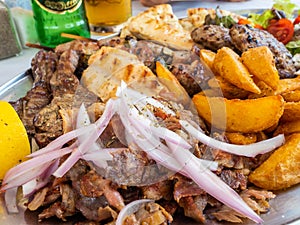 Tasty dish with greek tzatziki sauce, a mixture of various types of grilled meat