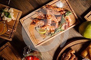 Tasty dish of large shrimps on a wooden table