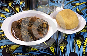 A Nigerian dish of Vegetable soup and Yellow Garri or Eba photo