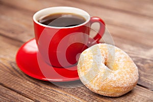 Tasty donut with a cup of coffee