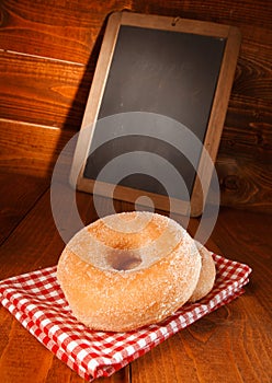 Tasty donut with vanilla sugar and a menu board