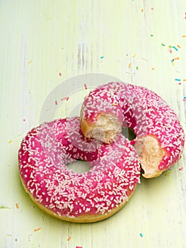 Tasty donuts with icing and pink chocolate