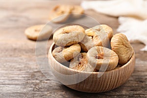 Tasty dried figs in bowl on table