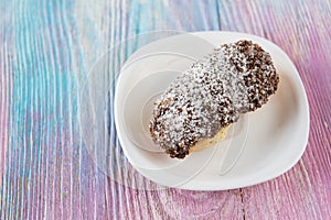 Tasty eclair on plate