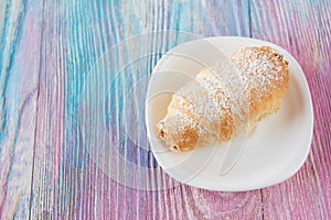 Tasty eclair on plate