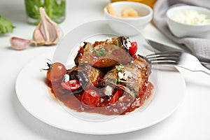 Tasty eggplant rolls served on white table, closeup