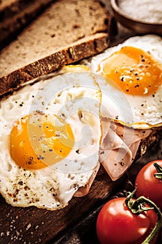 Tasty eggs, ham and tomato breakfast photo