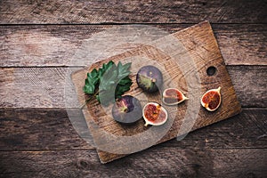 Tasty Figs on chopping board and wooden table