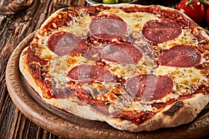 Tasty flame-grilled Italian salami pizza