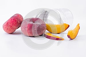 Tasty flat peach in slices and a whole flat peach - Flat red and ripe peach - On a white background