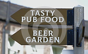 Tasty food and beer garden pub sign.