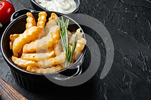 Tasty french fries with herbs, on black background , with copyspace  and space for text