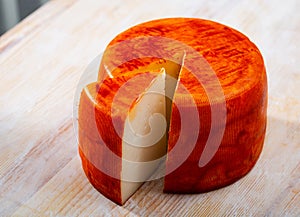 Tasty french goat cheese with pepper at wooden desk