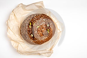 Tasty fresh baked loaf of dark bread with sesame seeds on white background