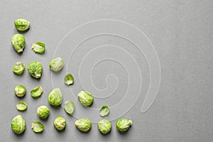 Tasty fresh Brussels sprouts on grey background, top view