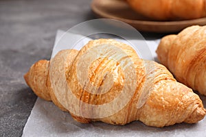 Tasty fresh croissants on table, closeup