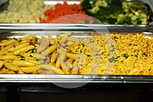 Tasty fresh homemade baked potatoes served on a metal tray. With various herbs, butter, garlic and salt. Gray stone