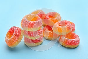 Tasty fresh jelly candies on color background