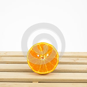 The tasty fresh orange half on wooden tray