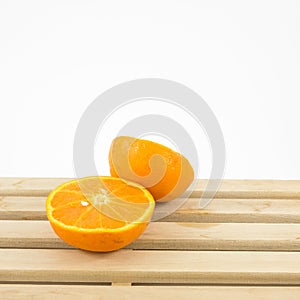 The tasty fresh orange half on wooden tray