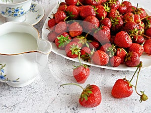 Tasty fresh strawberry with milk sour cream or yogurt closeup, dessert with strawberries