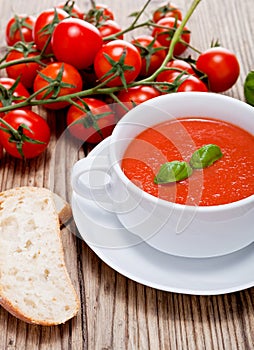 Tasty fresh tomato soup basil and bread