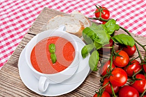 Tasty fresh tomato soup basil and bread