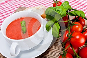 Tasty fresh tomato soup basil and bread