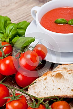 Tasty fresh tomato soup basil and bread