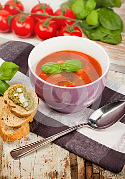 Tasty fresh tomato soup basil and bread