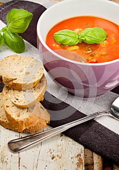 Tasty fresh tomato soup basil and bread