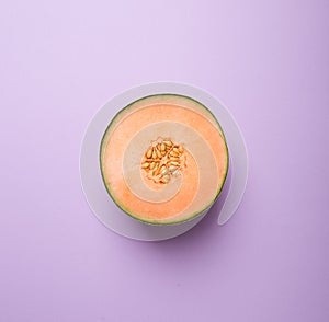 Tasty fresh yellow appetizing cut melon pastel background