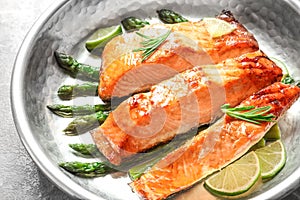 Tasty freshly cooked salmon in frying pan