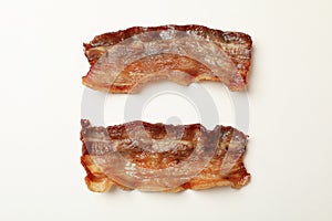 Tasty fried bacon slices on white background