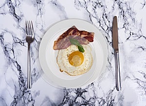 Tastu fried egg in plate with bacon