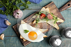 Tasty fried egg with bread, tomato and sprouts on wooden table, flat lay
