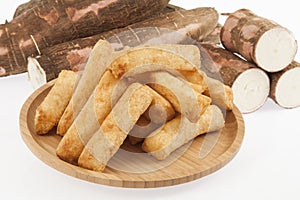 Tasty fried yucca sticks on white background