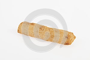 Tasty fried yucca sticks on white background