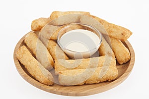 Tasty fried yucca sticks on white background