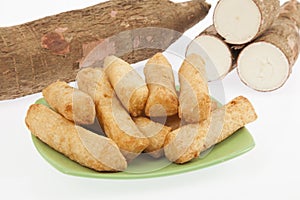 Tasty fried yucca sticks on white background