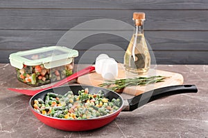 Tasty frozen vegetable mix on brown table